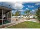 Screened patio, fire pit, and palm trees at 23102 Madelyn Ave, Port Charlotte, FL 33954
