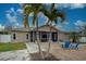 Screened patio, fire pit, and palm trees at 23102 Madelyn Ave, Port Charlotte, FL 33954