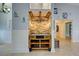 Built-in bar with stone backsplash and wooden shelving at 23102 Madelyn Ave, Port Charlotte, FL 33954