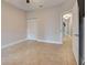 Bedroom with tile floors and a door to hallway at 23102 Madelyn Ave, Port Charlotte, FL 33954