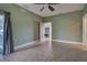 Light and airy bedroom with ceiling fan and tile floor at 23102 Madelyn Ave, Port Charlotte, FL 33954