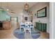 Charming dining area with round table, green buffet, and blue rug at 23102 Madelyn Ave, Port Charlotte, FL 33954