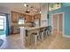 Kitchen boasts granite island, stainless steel appliances, and wooden cabinetry at 23102 Madelyn Ave, Port Charlotte, FL 33954