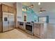Spacious kitchen with island, stainless steel appliances, and breakfast bar at 23102 Madelyn Ave, Port Charlotte, FL 33954
