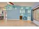 Living room with built-in shelving and light blue accent wall at 23102 Madelyn Ave, Port Charlotte, FL 33954