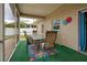 Screened patio with outdoor dining set and access to the house at 23102 Madelyn Ave, Port Charlotte, FL 33954