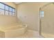 Relaxing bathroom with a corner tub and walk-in shower at 2331 Harrier Way, Nokomis, FL 34275