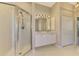 Elegant bathroom featuring a double vanity and a walk-in shower at 2331 Harrier Way, Nokomis, FL 34275