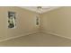 Well-lit bedroom featuring neutral carpeting and large windows at 2331 Harrier Way, Nokomis, FL 34275