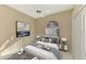 Bright bedroom with a queen-size bed and neutral decor at 2331 Harrier Way, Nokomis, FL 34275