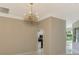 Bright dining room with chandelier and view into kitchen at 2331 Harrier Way, Nokomis, FL 34275