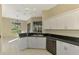 Kitchen with white cabinets, granite counters, and stainless steel appliances at 2331 Harrier Way, Nokomis, FL 34275