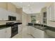 Kitchen with white cabinets, granite counters, and stainless steel appliances at 2331 Harrier Way, Nokomis, FL 34275