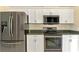 Kitchen with stainless steel appliances and white cabinets at 2331 Harrier Way, Nokomis, FL 34275