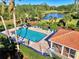 Community pool and clubhouse with palm trees and pond view at 2331 Harrier Way, Nokomis, FL 34275