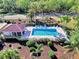 Community pool with lounge chairs and adjacent building at 2331 Harrier Way, Nokomis, FL 34275