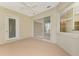 Sunroom featuring sliding glass doors and neutral flooring at 2331 Harrier Way, Nokomis, FL 34275