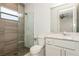 Elegant bathroom with a patterned shower wall and modern vanity at 2412 Magdalina Dr, Punta Gorda, FL 33950