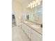 Bathroom with double vanity sinks and walk in closet at 2501 Sherman Oak Dr, North Port, FL 34289