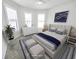 Cozy bedroom featuring a plush bed, decorative pillows, and bright natural lighting at 2501 Sherman Oak Dr, North Port, FL 34289