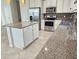 Modern kitchen featuring granite countertops, stainless steel appliances, and an island at 2501 Sherman Oak Dr, North Port, FL 34289