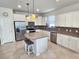 Elegant kitchen featuring a large island, stainless steel appliances, and pendant lighting at 2501 Sherman Oak Dr, North Port, FL 34289