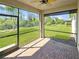 Screened lanai offering scenic views of the expansive backyard and adjacent landscaping, providing a private oasis at 2501 Sherman Oak Dr, North Port, FL 34289