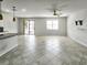 Bright living room featuring tile flooring, a ceiling fan, and sliding glass doors to the outdoor living space at 2501 Sherman Oak Dr, North Port, FL 34289