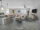 Open-concept living space featuring neutral-toned furnishings, tile flooring, and a kitchen with bar seating at 2501 Sherman Oak Dr, North Port, FL 34289