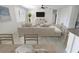 Bright living room with a neutral sofa, dining area, and an open layout at 2501 Sherman Oak Dr, North Port, FL 34289