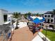 Inviting outdoor seating area with red and blue sunshades, set amidst a vibrant commercial district at 2501 Sherman Oak Dr, North Port, FL 34289