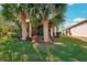 Landscaped backyard with lush lawn and tropical plants at 2572 Daisy Dr, North Port, FL 34289