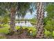 Landscaped backyard with pond and palm trees at 2572 Daisy Dr, North Port, FL 34289