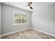 Spacious bedroom with wood-look floors and ceiling fan at 2572 Daisy Dr, North Port, FL 34289