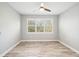 Bedroom with wood-look floors, window shutters, and ceiling fan at 2572 Daisy Dr, North Port, FL 34289