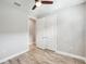 Light and airy bedroom with wood-look floors and double doors at 2572 Daisy Dr, North Port, FL 34289