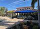 Community patio area with shaded tables and grills at 2572 Daisy Dr, North Port, FL 34289