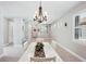 Open concept dining area with white table and kitchen views at 2572 Daisy Dr, North Port, FL 34289