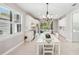 Open concept dining area with white table and kitchen views at 2572 Daisy Dr, North Port, FL 34289