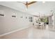 Bright dining room with white table and ceiling fan at 2572 Daisy Dr, North Port, FL 34289