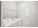 Convenient laundry room with washer, dryer, and shelving at 2572 Daisy Dr, North Port, FL 34289