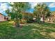 Neatly landscaped side yard with flowering bushes at 2572 Daisy Dr, North Port, FL 34289