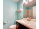 This cozy half-bath includes a stone countertop and modern fixture at 263 Southampton Dr # 301, Venice, FL 34293