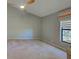 This large bedroom features neutral colored walls and carpet, and a fan at 263 Southampton Dr # 301, Venice, FL 34293
