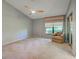 This bedroom has an armchair, fan, and a window with decorative valance at 263 Southampton Dr # 301, Venice, FL 34293