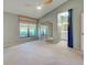 Large bedroom featuring neutral carpet, fan, closet, and an ensuite bathroom at 263 Southampton Dr # 301, Venice, FL 34293