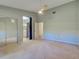 Spacious bedroom with neutral carpet, fan, access to an ensuite, and a sliding glass closet at 263 Southampton Dr # 301, Venice, FL 34293
