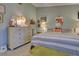 Bedroom with a king-size bed, light green walls, unique dresser, and soft carpet at 263 Southampton Dr # 301, Venice, FL 34293