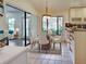 Bright dining area with a chandelier and a view to the outside through the large windows at 263 Southampton Dr # 301, Venice, FL 34293