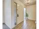 Welcoming entryway features wood-look floors, a translucent window, and a white front door at 263 Southampton Dr # 301, Venice, FL 34293
